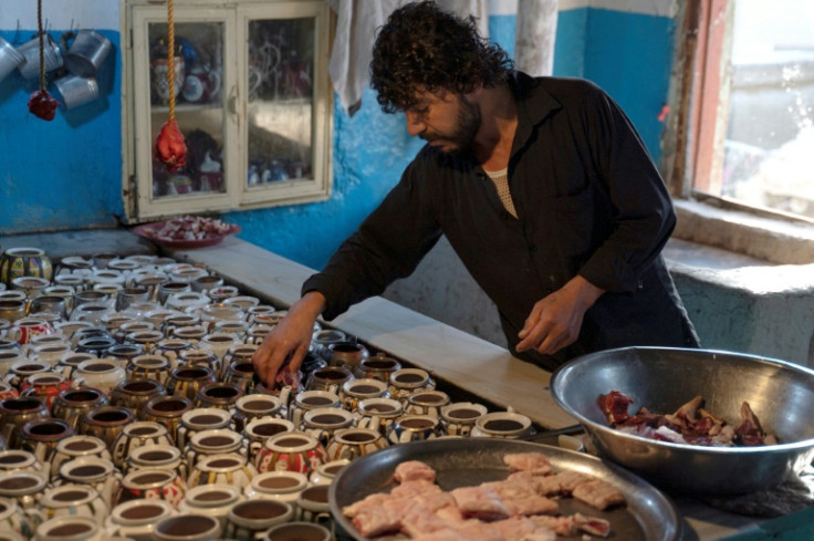 Chef Waheed adds lamb meat and fat to little teapots to prepare an Afghan dish called "chainak" in the capital, Kabul