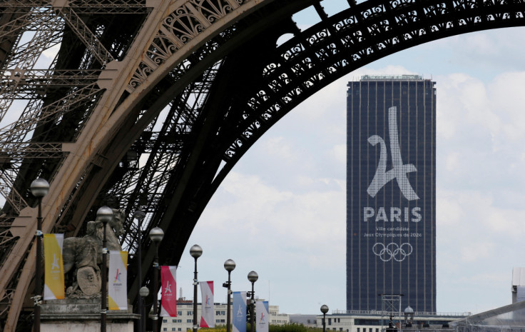 The logo of the Paris candidacy for the 2024 Olympic and Paralympic Games is seen on the Montparnasse tower behind the Eiffel Tower in Paris