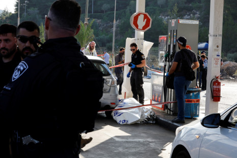 Security personnel work at the scene of a suspected Palestinian shooting attack near the Jewish settlement of Eli