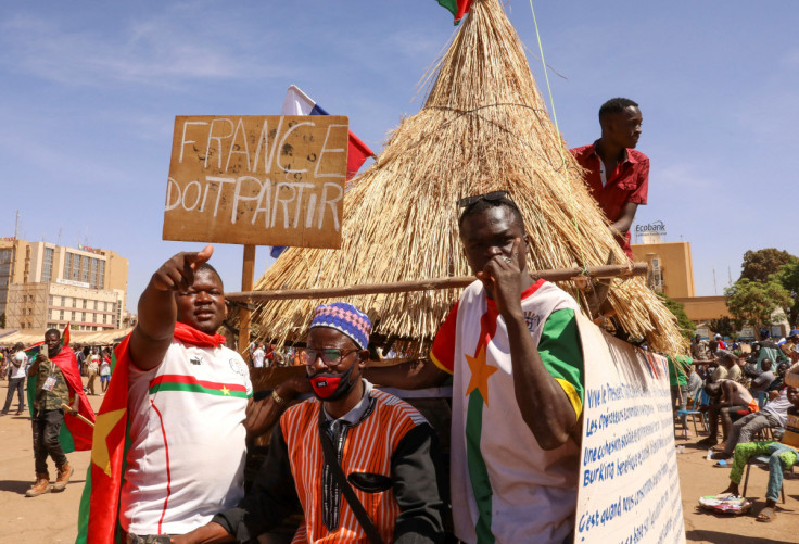People hold a sign to show their support to the Junta leader Ibrahim Traore and demand the departure of the French ambassador in Ouagadougou