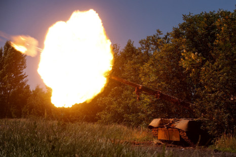 Ukrainian servicemen fire a T-80 main battle tank captured earlier from Russian troops, in a field near the front line town of Bakhmut
