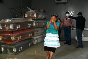 A woman cries after recognising her daughter among the 46 who died in violence at the CEFAS women's prison in Honduras