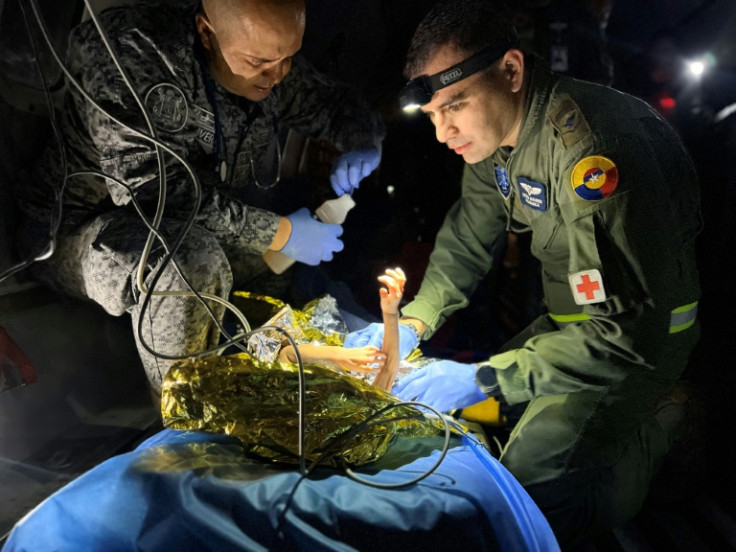 Airmen from Colombia's air force evacuate the rescued children on June 9, 2023