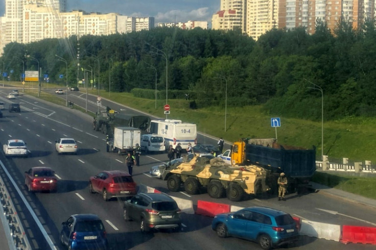 Russian police officers and servicemen block part of a highway entering Moscow on June 24, 2023