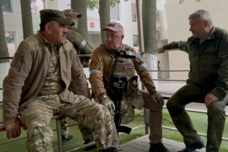 Yevgeny Prigozhin (C) with senior Russian defence officials inside the Russian military HQ in Rostov-on-Don