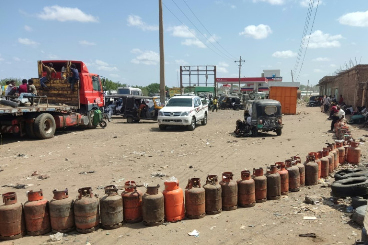 People wait for a new shipment of liquefied petroleum gas (LPG) cylinders in the Sudanese city of Gadaref