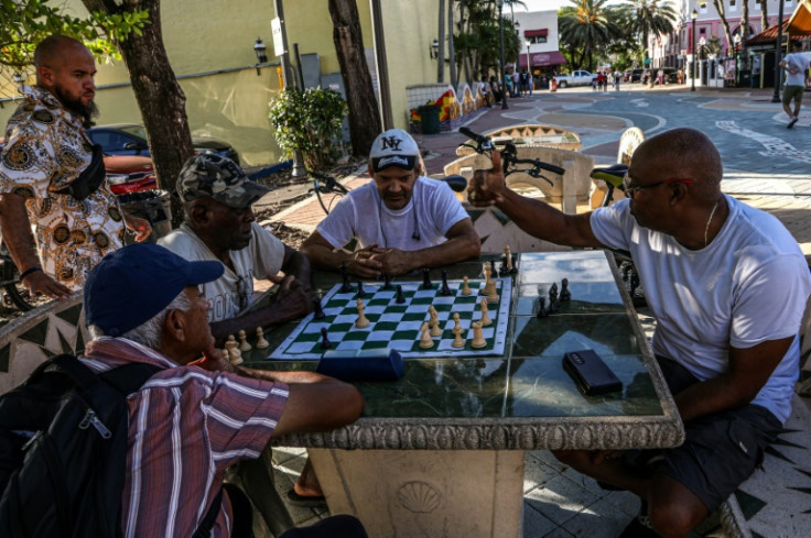 Men entertain themselves with a sidewalk game of chess in the Little Havana neighborhood of Miami, Florida, on June 26, 2023