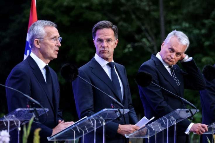 NATO Secretary General Jens Stoltenberg (L) said the organization will protect allies 'against Moscow or Minsk'