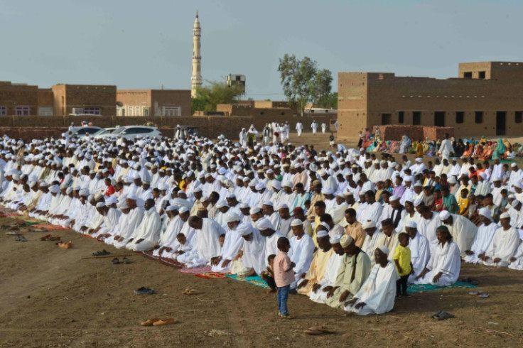 Sudanese Muslim worshippers who fled violence in Khartoum gather for Eid al-Adha prayers in Jazira region, south of the capital