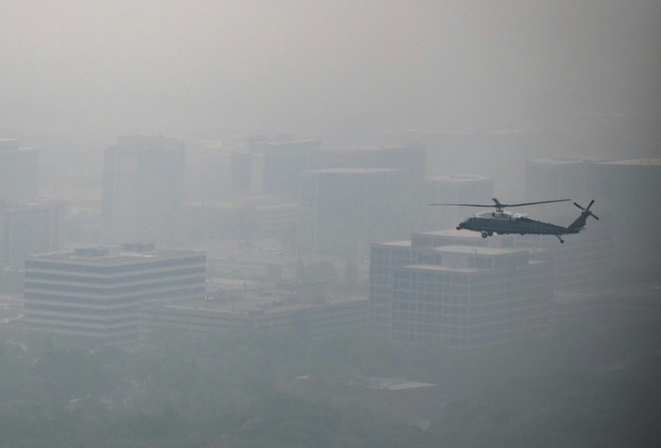 The presidential helicopter Marine One flies with Joe Biden over a hazy Chicago, Illinois