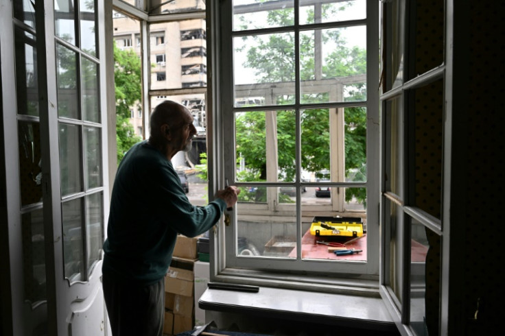 Local resident Volodymyr, 74, repairs his broken windows after a Russian missile strike on Kramatorsk this week