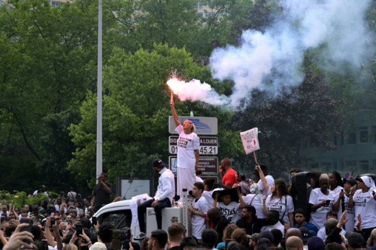 Nahel's mother Mounia waved a flare while riding on a truck during the protests