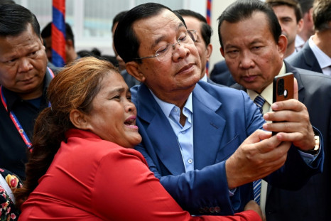 Cambodian Prime Minister Hun Sen (C) has long been a prolific Facebook user