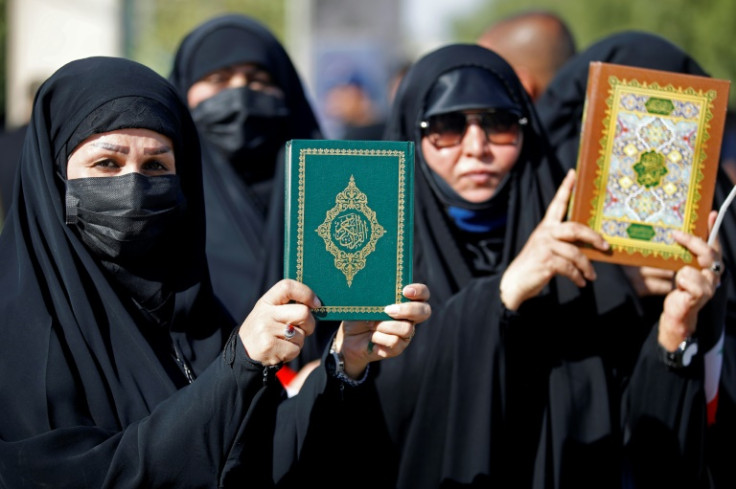 Female supporters of firebrand Shiite Muslim cleric Moqtada Sadr hold up copies of the Koran during a Baghdad protest against its desecration by a fellow Iraqi in Sweden