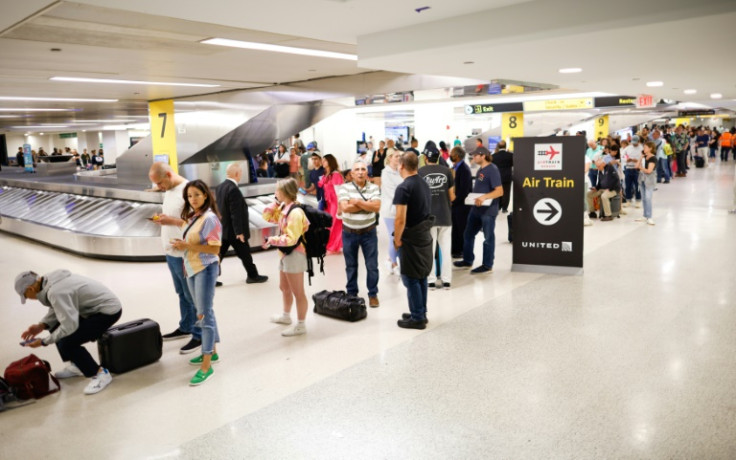 Travelers assemble and await the rescheduling of their flights at Newark International Airport on June 27, 2023 in Newark, New Jersey