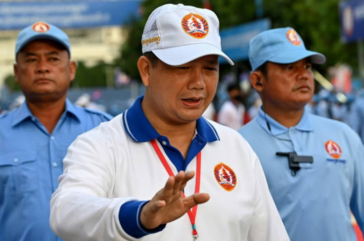 Hun Sen has made it clear he wants his son, Hun Manet (C), to succeed him