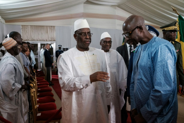 Supporters of Senegal's President Macky Sall (C) claim a revision of the constitution allows him to run again even though he has served two terms