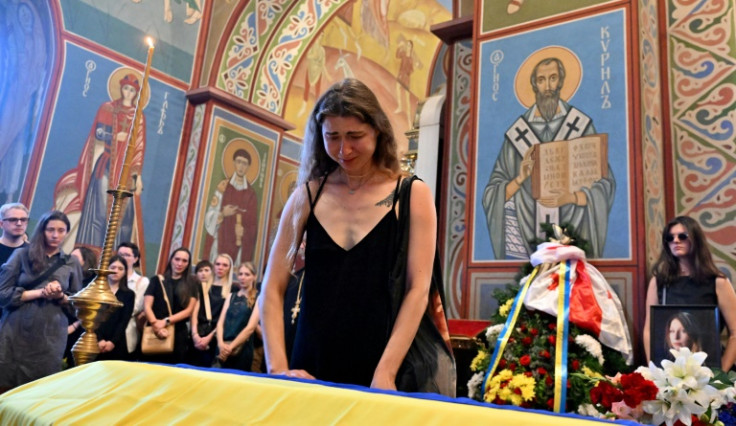 A mourner at the funeral of Victoria Amelina, who was dining at the Ria Pizza restaurant in Kramatorsk when a Russian strike hit