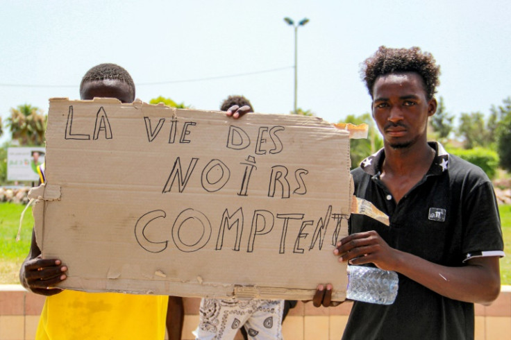 Migrants display the slogan "Black Lives Matter" in French at a protest in Sfax