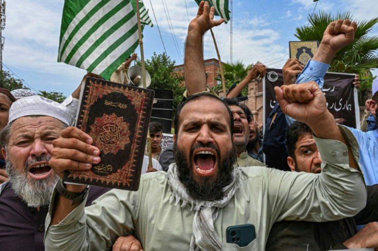 A man holding a copy of the Koran shouts slogans during a demonstration in Peshawar