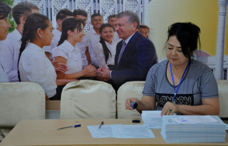 Members of a local election commission prepare a polling station in Tashkent