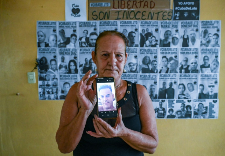 Liset Fonseca holds a photo of her son Roberto, who was taken away by Cuban security during a July 2021 pro-democracy uprising