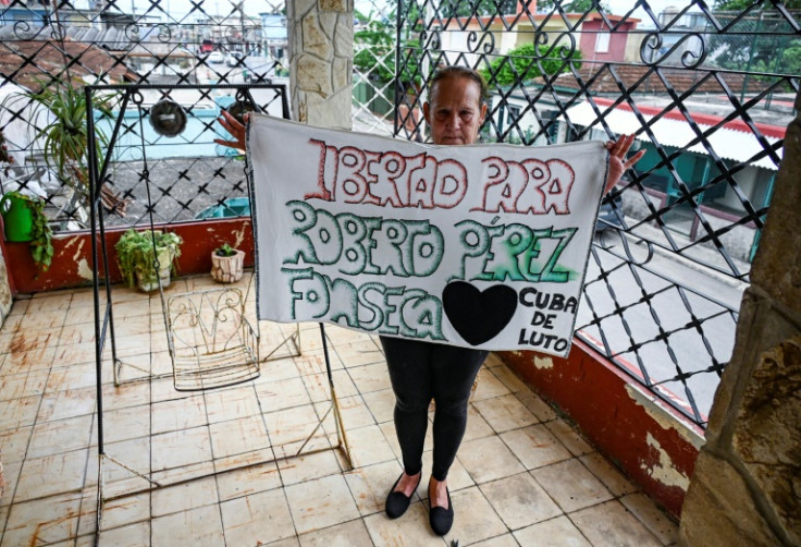 Liset Fonseca, mother of Roberto Perez Fonseca, a detainee since pro-democracy protests erupted in 2021, holds a sign demanding his release from prison