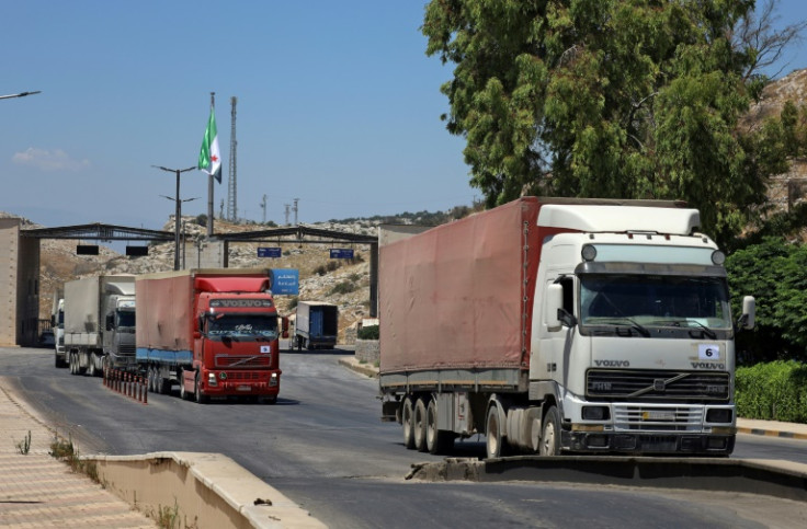 A picture taken on July 28, 2022 shows the entry of a United Nations aid convoy through the Bab al-Hawa border crossing with Turkey