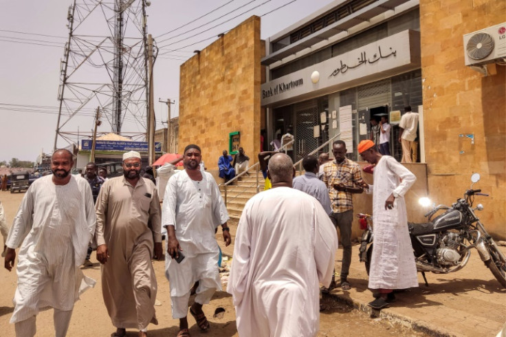 People outside a Bank of Khartoum branch in Gedaref, which like institutions across Sudan has struggled to provide services since the war began
