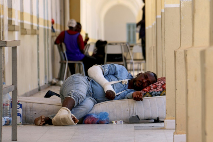 An injured migrant who fled the violence in Sfax is now at a temporary shelter at a school in Ben Guerdane
