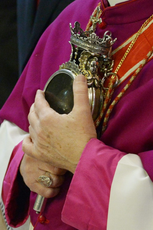 A bishop holds an ampoule containing the blood of San Gennaro, the patron saint of Naples