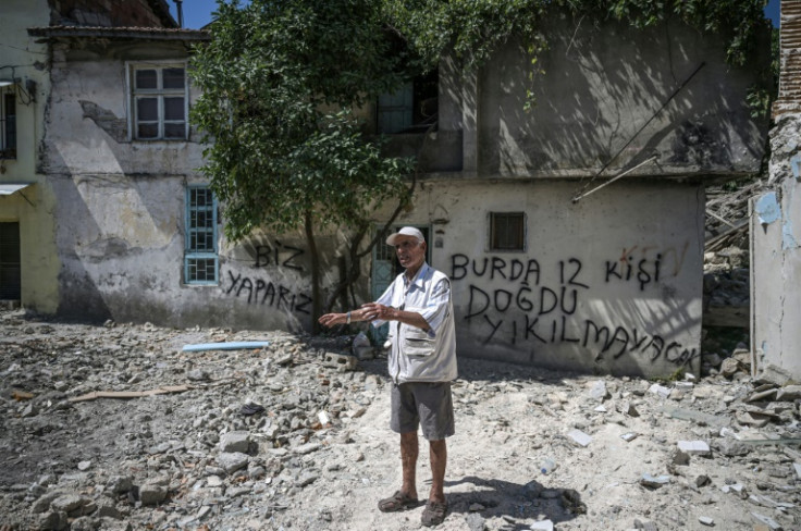 Vahit Baklaci, a 82-year-old priest, stands before the damaged house where he was born in in Antakya, Turkey