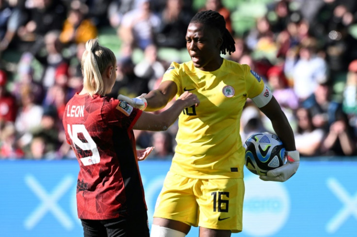 Nigeria's goalkeeper Chiamaka Nnadozie (R) speaks with Canada's forward Adriana Leon during the World Cup Group B football match in Melbourne