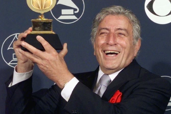 Tony Bennett holds holds up one of his multiple Grammy awards in 1998 in New York