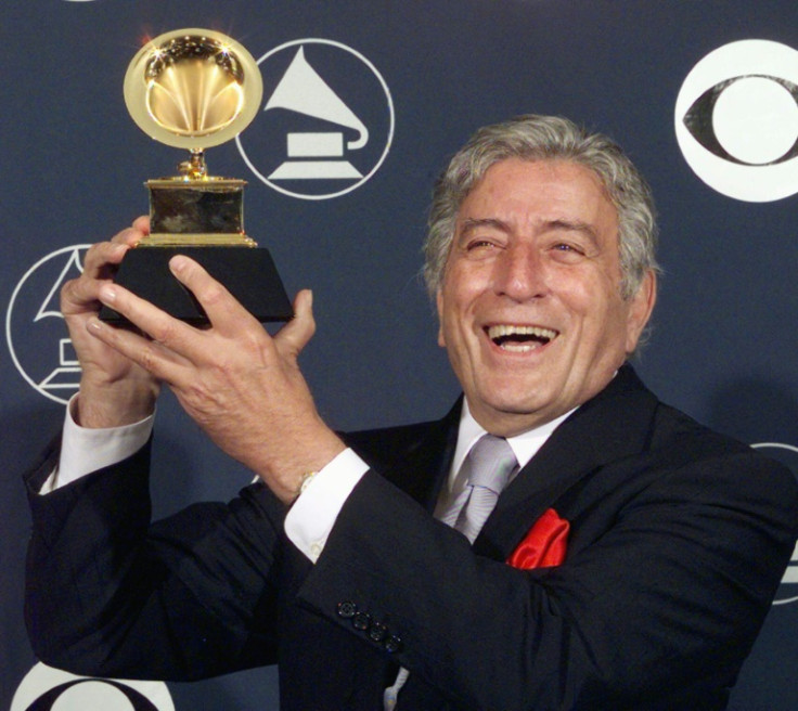 Tony Bennett holds holds up one of his multiple Grammy awards in 1998 in New York