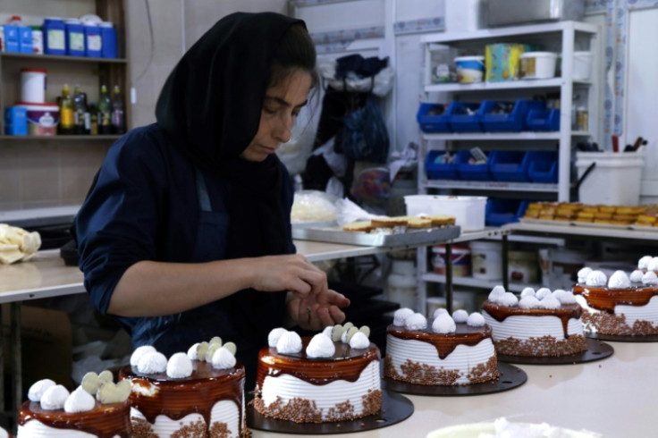 An Iraqi Kurdish woman works in the sweets shop named after Mahsa Amini