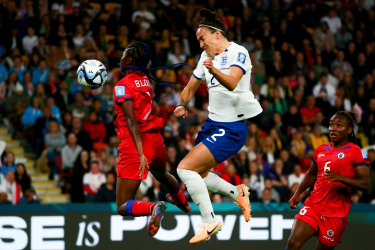 Haiti forward Batcheba Louis (L) and England defender Lucy Bronze  contest a header