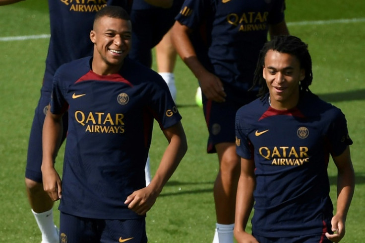 Kylian Mbappe (L) and his younger brother Ethan take part in a PSG training session