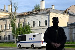 Police secure an area outside a damaged non-residential building on Moscow's Komsomolsky Prospekt after a reported drone attack on July 24, 2023