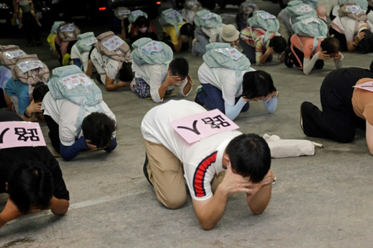 Local residents take shelter during an air raid drill in Taipei
