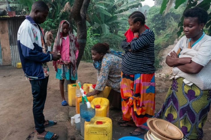 A woman fills a jerrycan with water in Selembao, a poor neighbourhood with very little water or electricity on the outskirts of Kinshasa