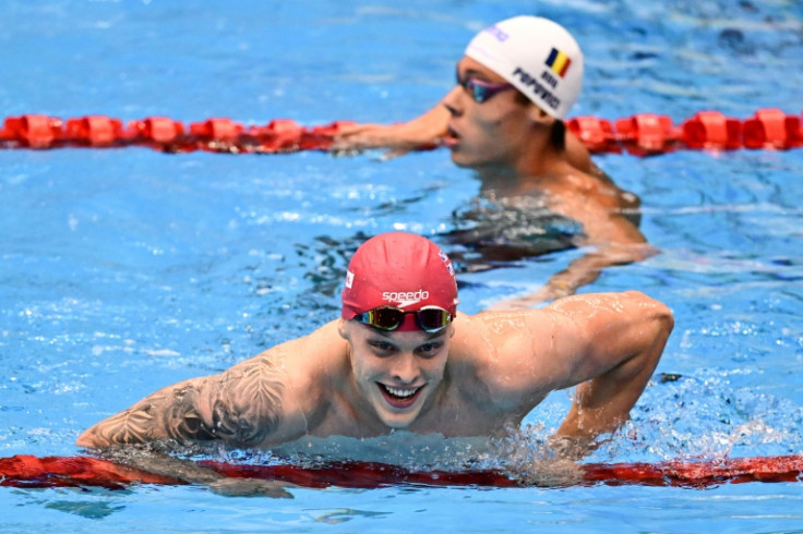 Britain's Matthew Richards (front) leaves the pool next to Romania's David Popovici after his victory in the final of the men's 200m freestyle swimming event during the World Aquatics Championships