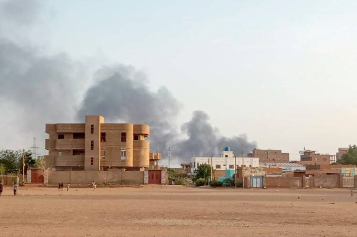 Smoke billows in the distance behind homes in Khartoum's Bahri district on July 14, 2023