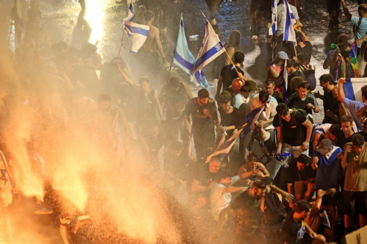 Demonstrators in Tel Aviv are sprayed with water cannon by Israeli riot police during a protest against the government's judicial overhaul plan, on July 24, 2023