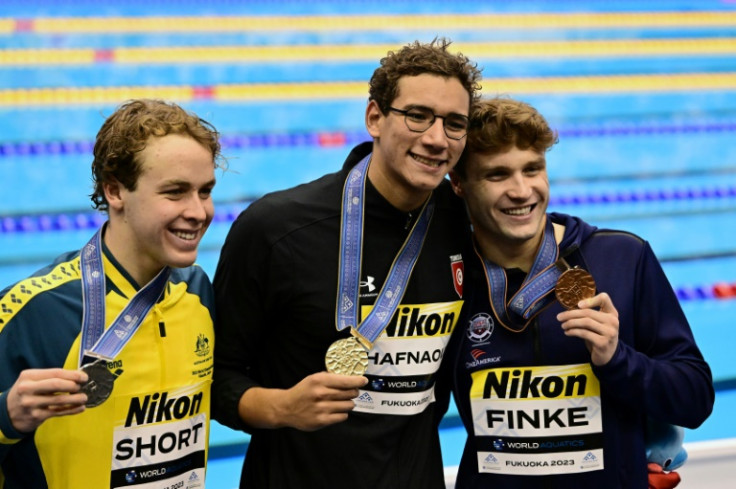 (L-R) Silver medallist Australia's Samuel Short, gold medallist Tunisia's Ahmed Hafnaoui and bronze medallist USA's Bobby Finke pose during the medals ceremony for the men's 800m freestyle swimming event during the World Aquatics Championships