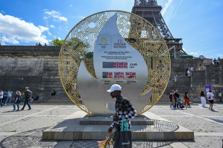 A clock counting down to the start of the 2024 Paris Olympics Games in front of the Eiffel Tower