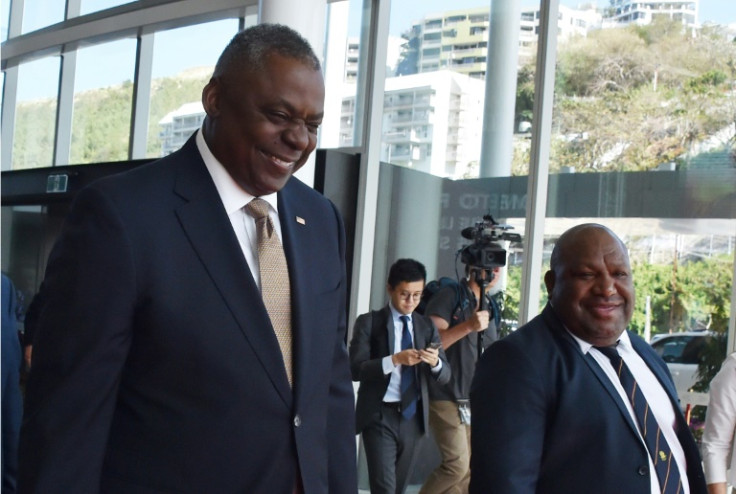 Papua New Guinea Defence Minister Win Bakri Daki (R) and US Secretary of Defense Lloyd Austin walk to their meeting in Port Moresby on Thursday