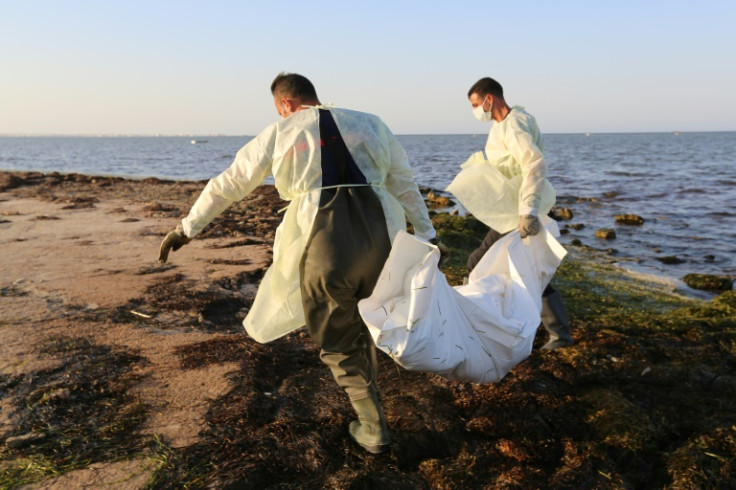 Tunisian civil protection workers recover the body of an African migrant near the eastern city of Zarzis, on July 16, 2019, after a string of deadly shipwrecks