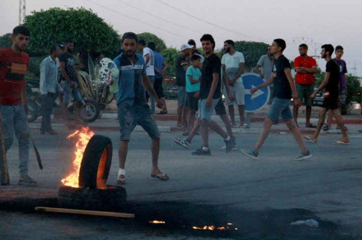 Tunisian youths blocked the road to migrants as tensions rose in Sfax after the burial of a young Tunisian stabbed to death during a scuffle between residents and migrants from sub-Saharan Africa, on July 4, 2023