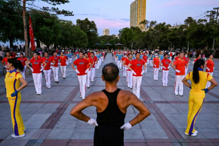 Participants in Jiamusi Happy Dancing perform a series of unconventional moves, from strutting with puffed-out chests to pinwheeling their arms